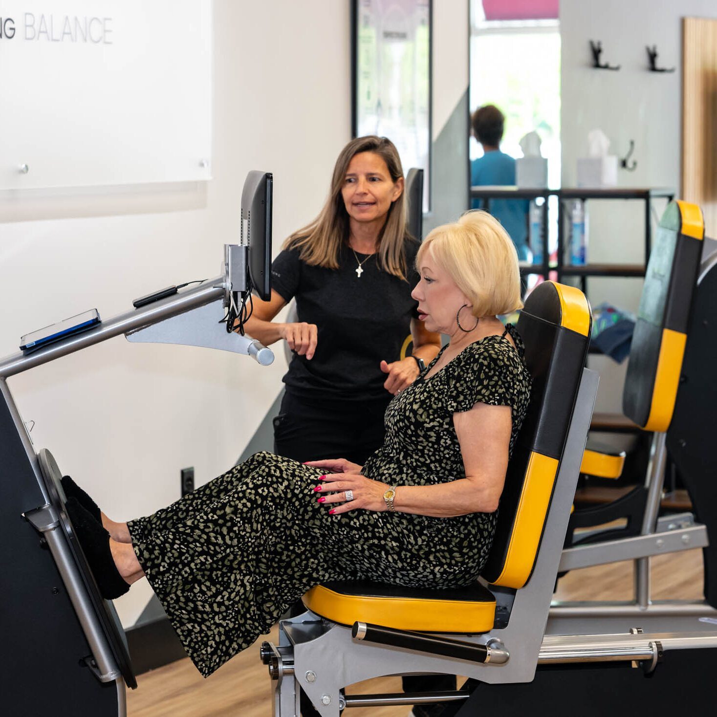 Woman exercising on a seated machine.